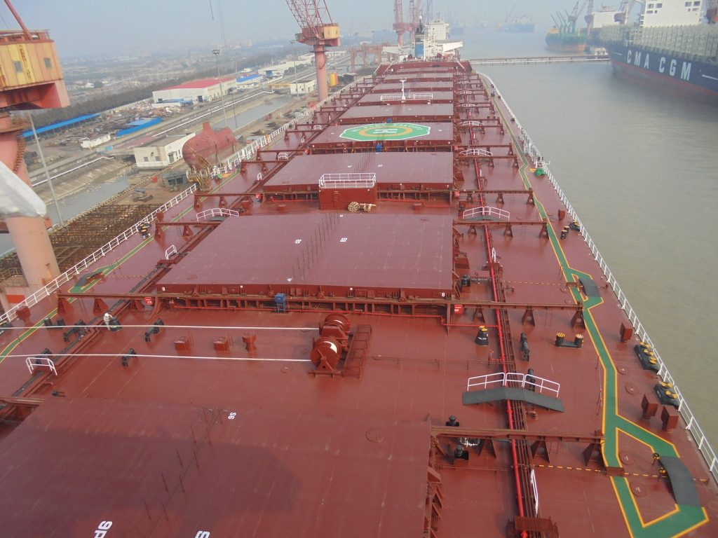 Deck of a Capesize bulk carrier at the yard showing hatch covers and helicopter winch area