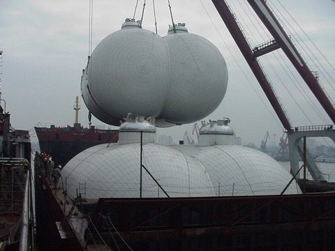 Spherical LPG cargo tanks being lifted into the hull at the shipyard